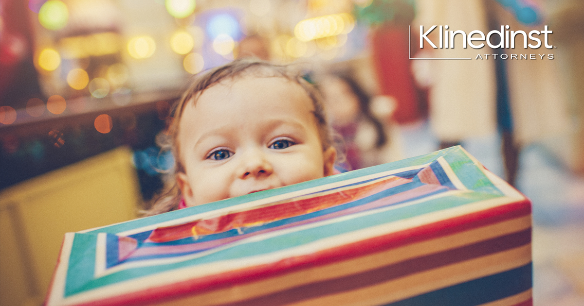 Child holding holiday present.